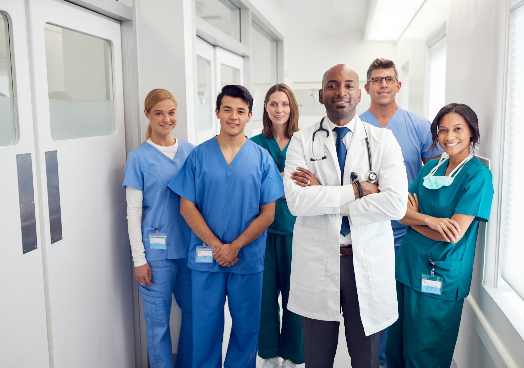portrait-of-multi-cultural-medical-team-standing-in-hospital-corridor.jpg